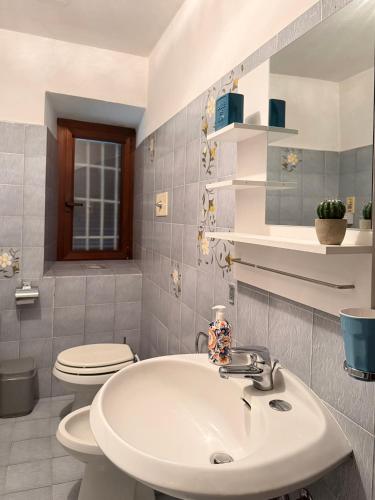 a bathroom with a sink and a toilet at Mountain Getaway Panoramic View - Pets Welcome in Gromo