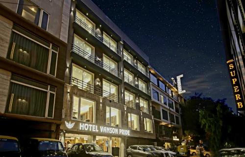 a hotel with cars parked outside of it at night at The Vanson Pride, Delhi Central Stay in New Delhi