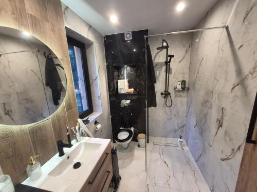 a bathroom with a sink and a shower and a toilet at Sauna-ForRest in Marynin