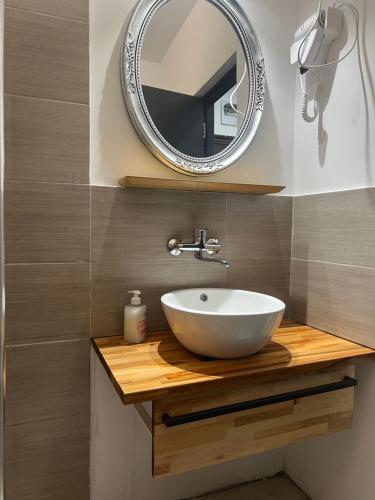 a bathroom with a white sink and a mirror at EFORIE STUDIOS in Eforie Nord
