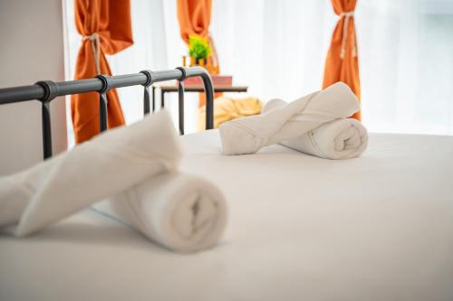 two rolls of toilet paper on a bed at Central Summer Theatre Suites in Veliko Tŭrnovo