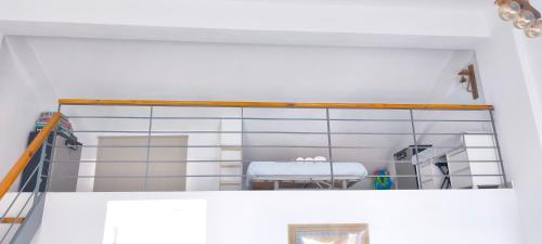 a room with a glass staircase with a table at Green Boat House in Skala