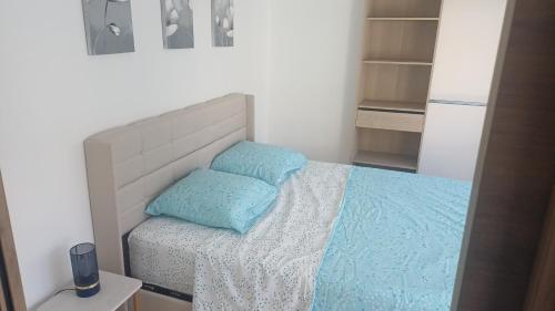 a bedroom with a bed with two pillows on it at Appartement lena in Boulogne-sur-Mer