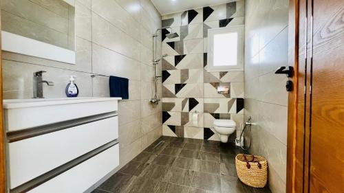 a bathroom with a toilet and a sink at Corail in Djerba