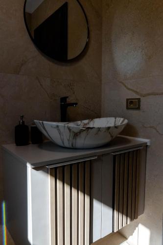 a bathroom with a sink and a mirror on a counter at Mira Montis in Borşa