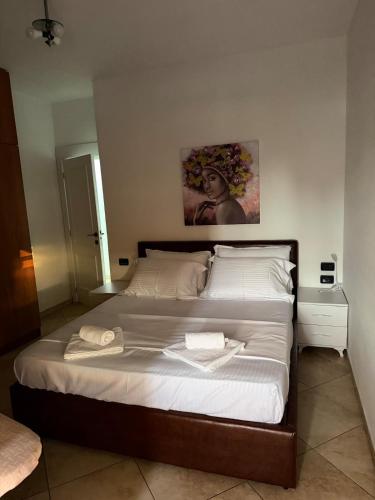 a bedroom with a large bed with two towels on it at Tirana Skyline Apartment in Tirana