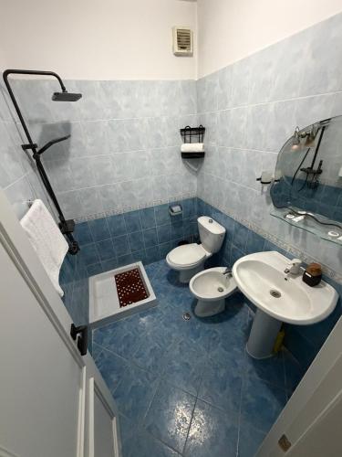 a bathroom with two toilets and a sink at Tirana Skyline Apartment in Tirana