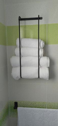 a bunch of towels are hanging in a bathroom at Coquet ac accès autonome in El Aouina Station