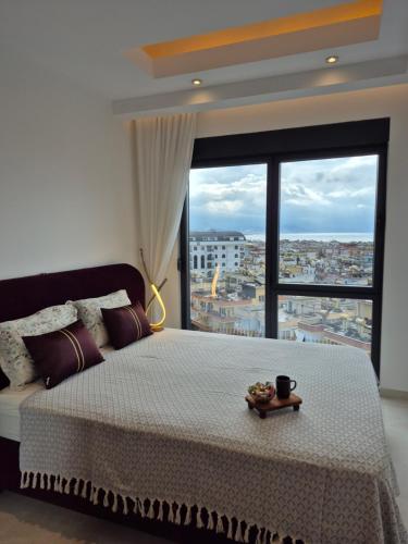 a bedroom with a large bed with a large window at Luxury apartment with panoramic sea view ruby in Alanya