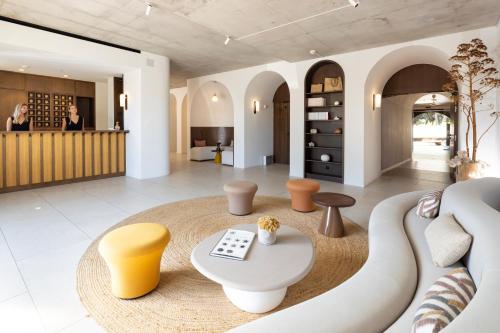 a living room with a couch and a table at Hôtel Spa & Restaurant - Son de Mar in Porto-Vecchio