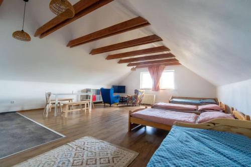 a living room with two beds and a dining room at Apartmán 7J in Hnanice