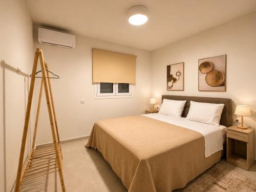 a bedroom with a bed and a tripod at ΕΝ ΑΛΩ Residences in Kiveri