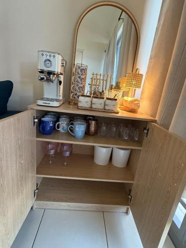 a cupboard with a coffee maker and a mirror at Villa Marelena Beachfront Villa Aguada Near Rincón in Tablonal