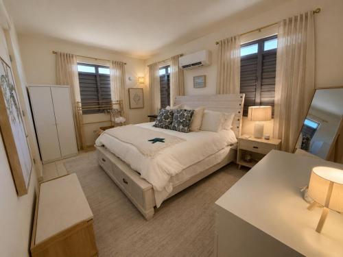 a bedroom with a large bed and a desk at Villa Marelena Beachfront Villa Aguada Near Rincón in Tablonal