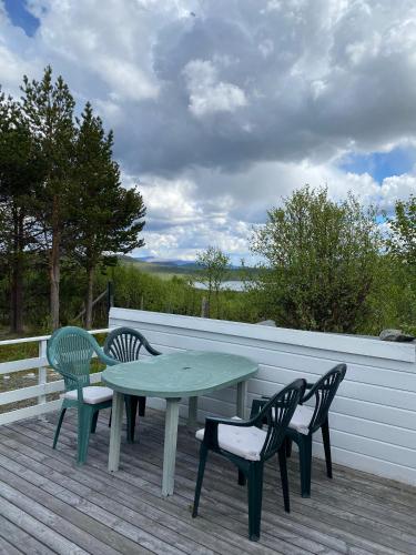 a table and two chairs on a deck at Snøhetta Camping in Hjerkinn