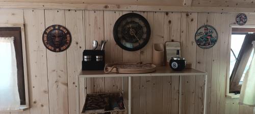 a wooden wall with plates and a shelf in a room at Maringotka pod hvozdem in Spešov