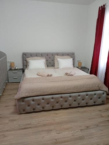 a bedroom with a large bed with two pillows at FeWoZentrum in Lüdenscheid