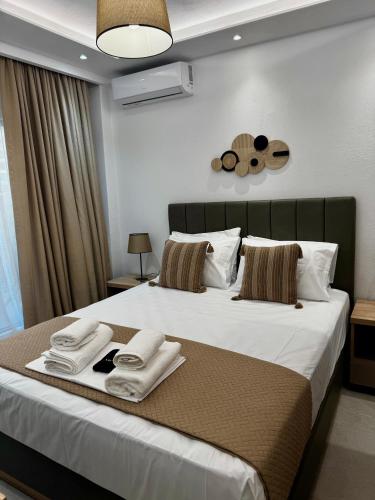a bedroom with a large bed with towels on it at Malama's apartment in Neos Marmaras