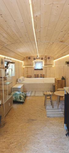 a room with a bed and a table in a room at Maringotka pod hvozdem in Spešov