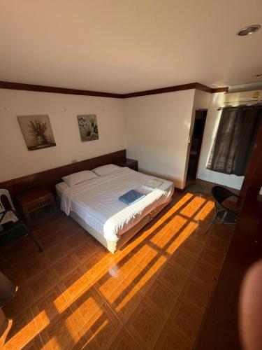 a bedroom with a bed in the middle of a room at Vibes Solution in Patong Beach