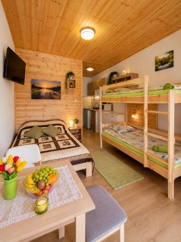 a room with two bunk beds and a table at Admiral aqua resort in Mielno