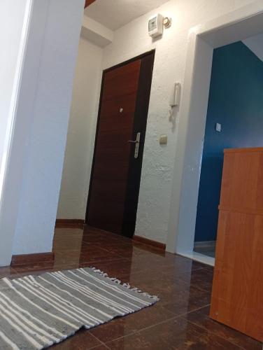 a hallway with a door and a rug on the floor at Ewula in Giżycko