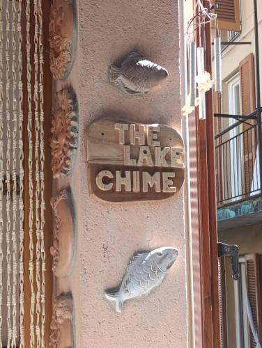 a sign on the side of a building with fish on it at The Lake Chime in Colonno