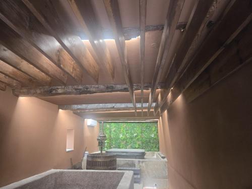a bathroom with a wooden ceiling and a window at Provesende Douro Villas - Casa Principal in Provesende