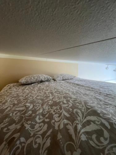 a bed with two pillows on it in a bedroom at Tiny house with lake view in Hammarö