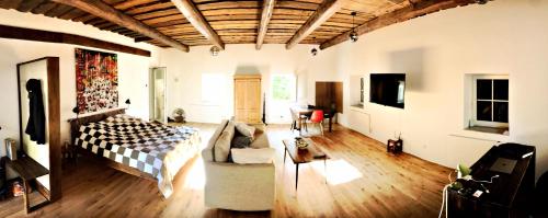 a bedroom with a bed and a couch in a room at Phreude Loft in Aschach an der Donau