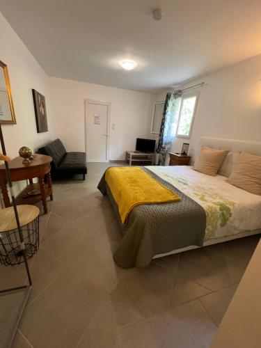 a bedroom with a bed and a living room at Chamalobri in Labeaume