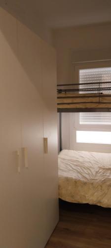 a bedroom with a bunk bed and a window at O rincón do Mimo in Ribeira