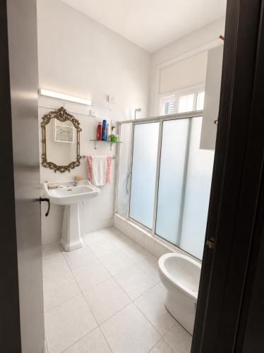 a bathroom with a toilet and a sink and a mirror at Chambre du jardin in Rabat