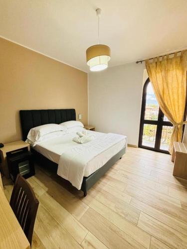 a bedroom with a large bed and a large window at Hotel Virginia in Marina di Massa