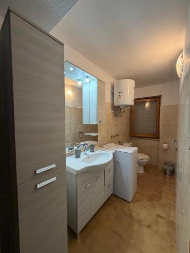 a bathroom with a sink and a toilet at Castelsardo Homes in Castelsardo