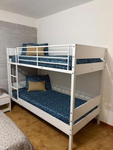 a room with three bunk beds in a room at Castelsardo Homes in Castelsardo