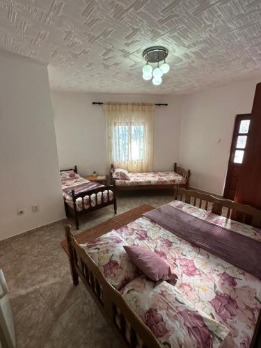 a bedroom with two beds in a room with a ceiling at Apartmani Becic in Sutomore
