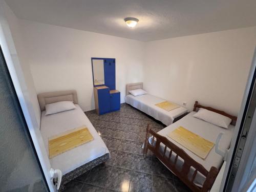 a room with two beds and a mirror at Private guest-house Gutic in Sutomore