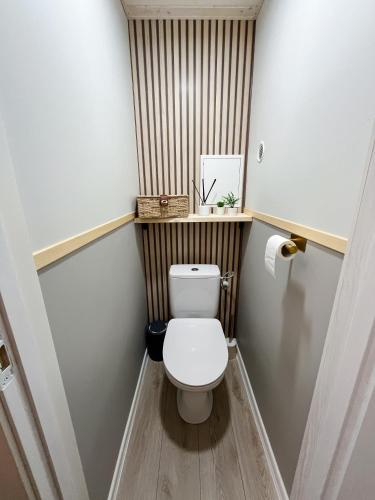 a small bathroom with a toilet in a room at 2-Room Apartment in Lahemaa Near the Sea in Loksa