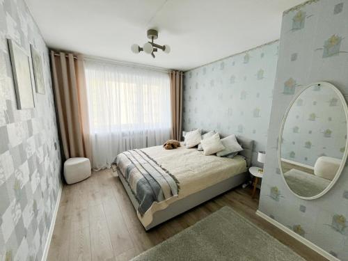 a bedroom with a bed and a large mirror at 2-Room Apartment in Lahemaa Near the Sea in Loksa