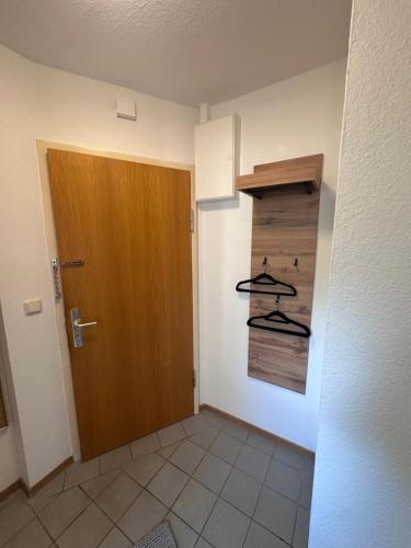 a room with a door and some hangers at Ferienwohnung Waldblick in Harrislee