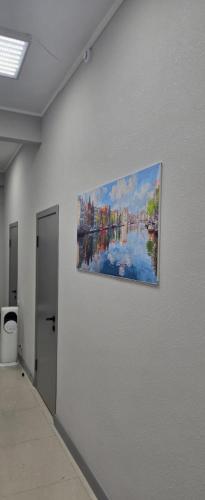 a painting hanging on a wall in a room at Astana Rooms in Astana
