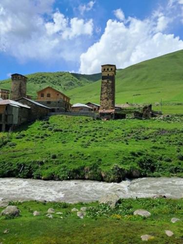 a building on a hill next to a river at ENO Grand Mountain Escape in Murkmeli