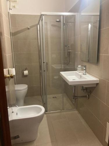 a bathroom with a shower and a toilet and a sink at Albergo Italia in Ancona