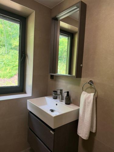 a bathroom with a white sink and a mirror at Motel Gradina in Bosansko Grahovo