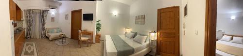 a bedroom with a bed and a living room at Alexandra's House in Skiathos