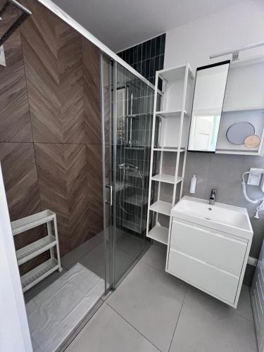 a bathroom with a shower and a toilet and a sink at Na Pokładzie in Dębki