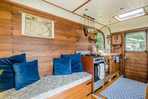 an rv kitchen with blue pillows and a stove at 1 Bed in Elsing oc-d44229 in Elsing
