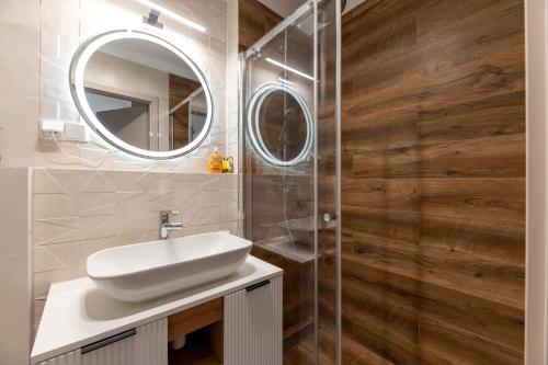 a bathroom with a sink and a mirror at Helskafoka2 in Hel