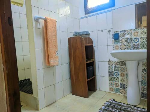 a small bathroom with a sink and a toilet at Villa Étage Z Irma in Antsiranana